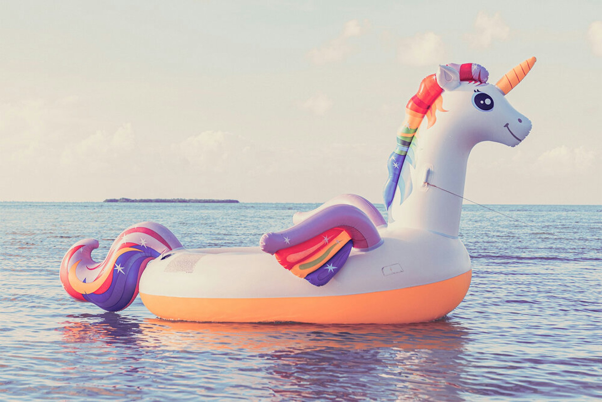 An inflatable unicorn on water.