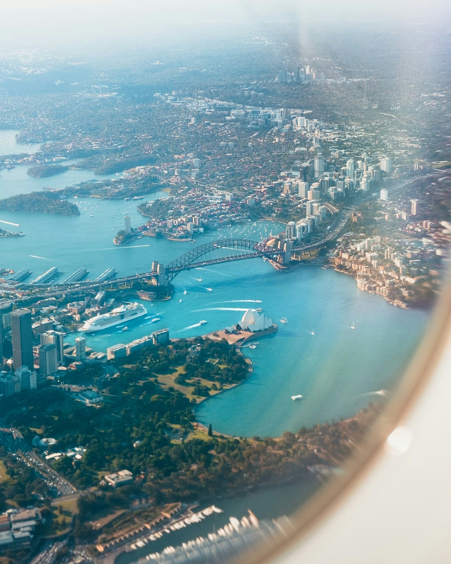 Sydney Harbour as seen from an airplane window.