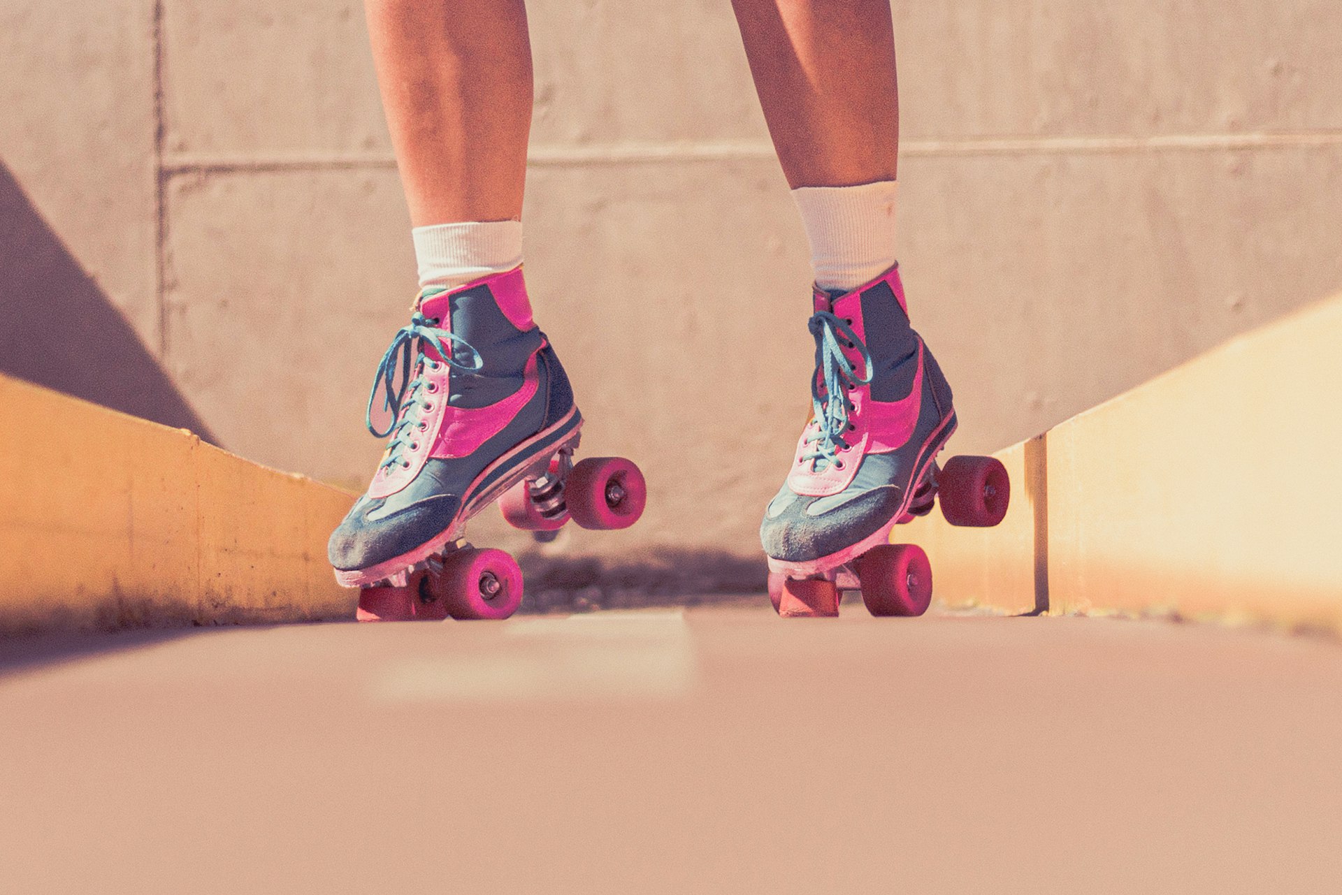 A person on roller skates, tilted on their toes.