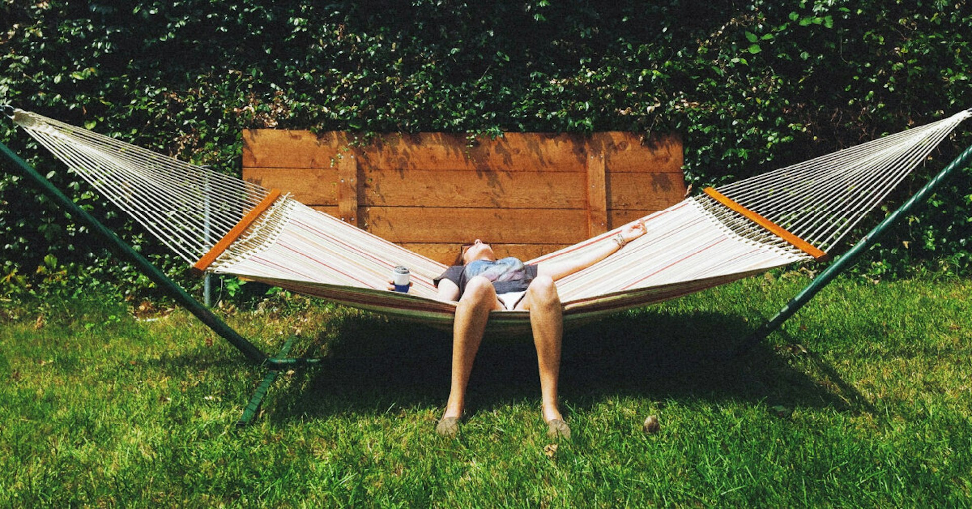 A person lies back on a hammock.