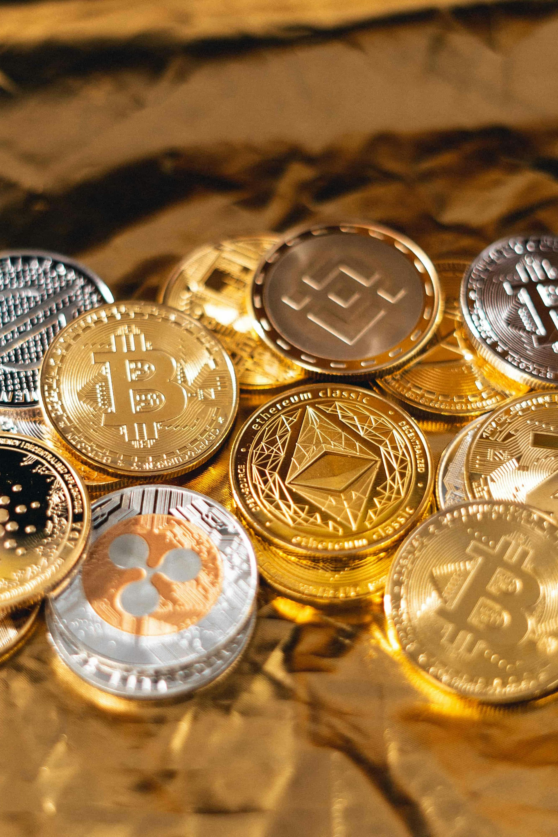 A selection of coins representing cryptocurrencies are clustered together.