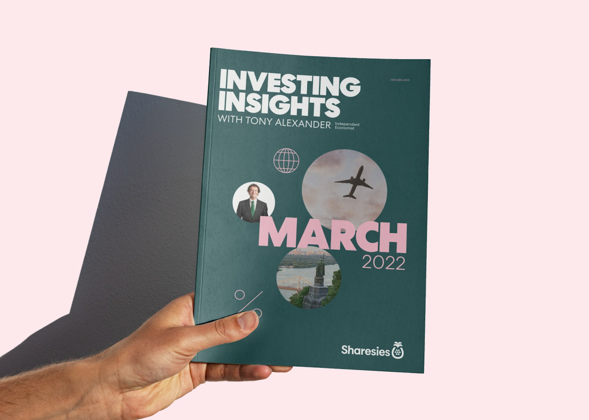 The March Investing Insights report is held in a hand in front of a pink backdrop.