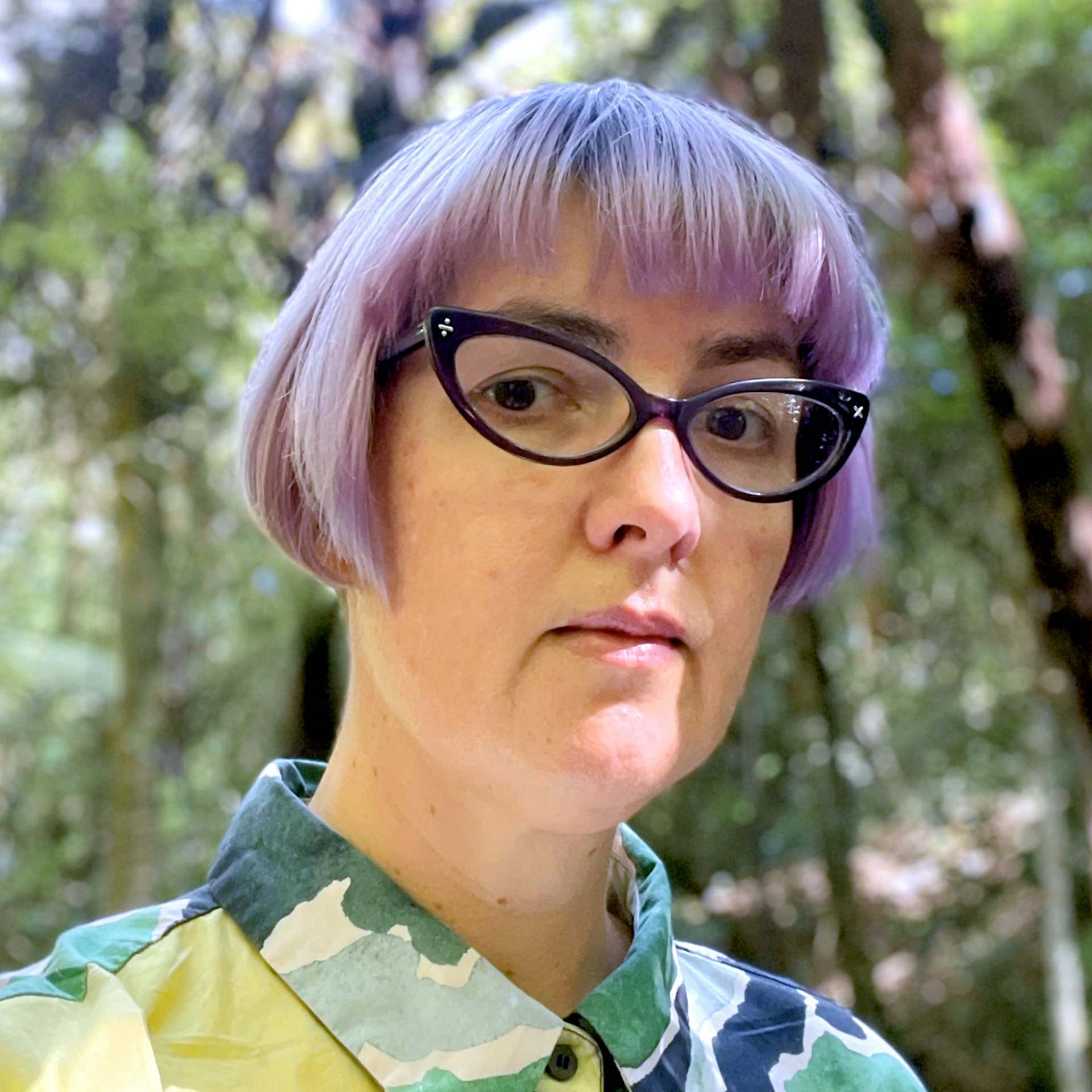 Portrait of Petra Smith, Sharesies Security Manager, complete with purple hair. 